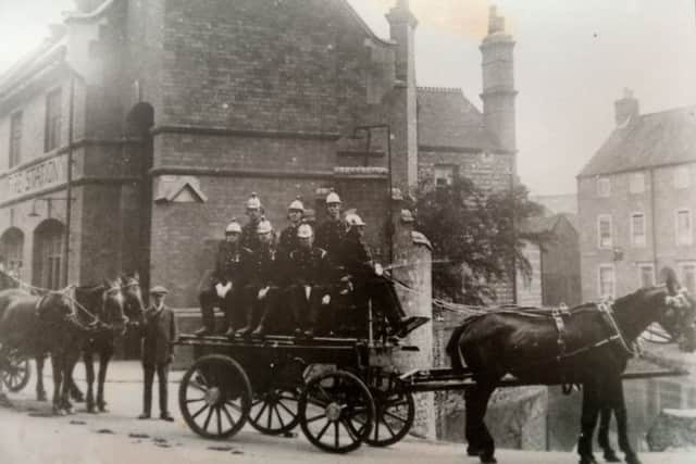 An old image of the fire and and its crew hung on the wall of the building company's new office premises. EMN-181203-172644001